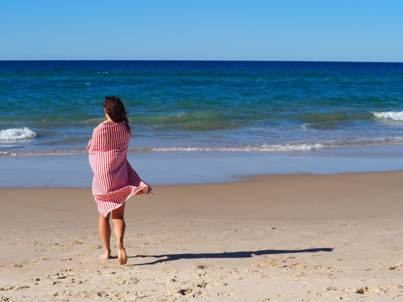 woman on beach with turkish towel portsea cherry