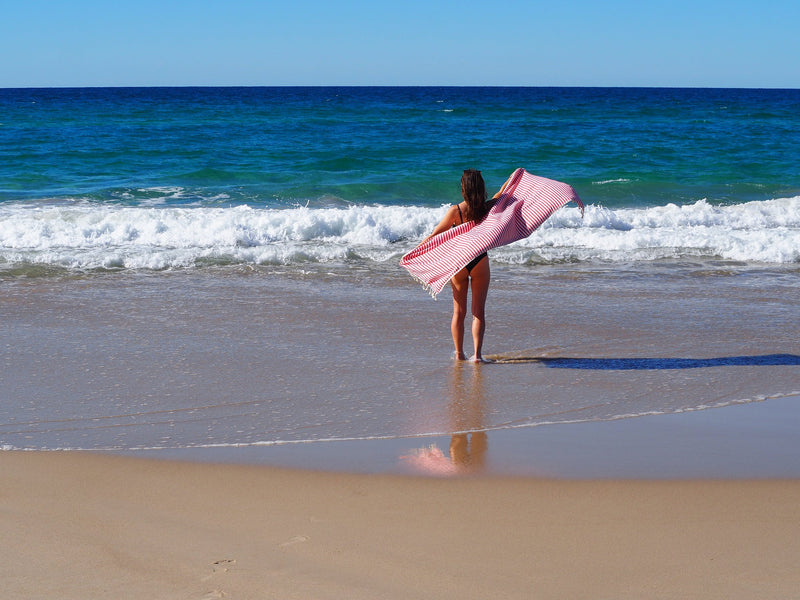 woman on beach with turkish towel portsea cherry