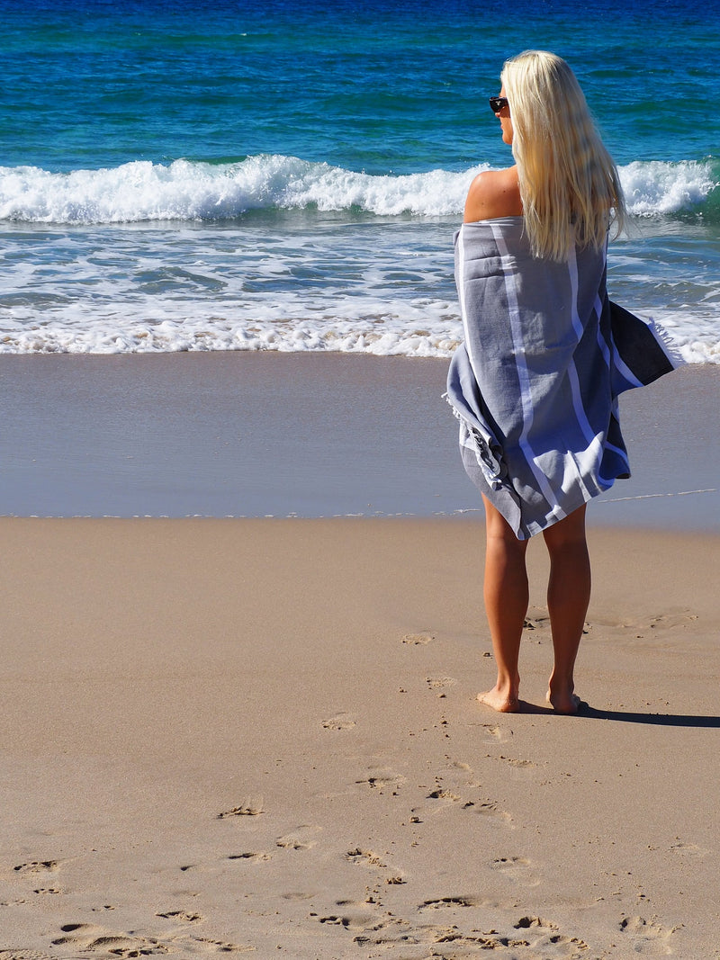 woman on beach with SORRENTO TURKISH COTTON TOWEL - MONOCHROME