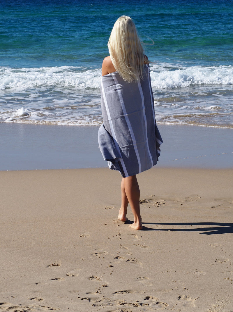 woman on beach with SORRENTO TURKISH COTTON TOWEL - MONOCHROME