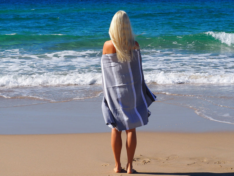 woman on beach with SORRENTO TURKISH COTTON TOWEL - MONOCHROME