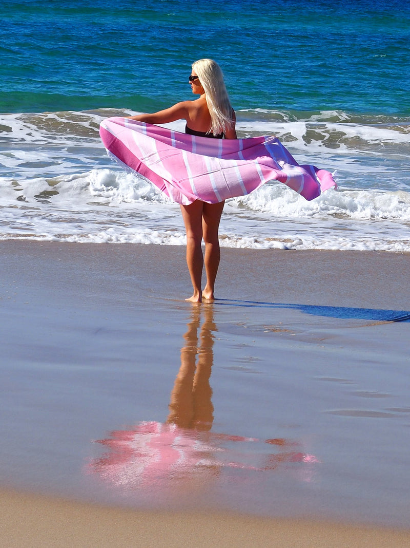 woman on beach with SORRENTO TURKISH COTTON TOWEL - CANDY