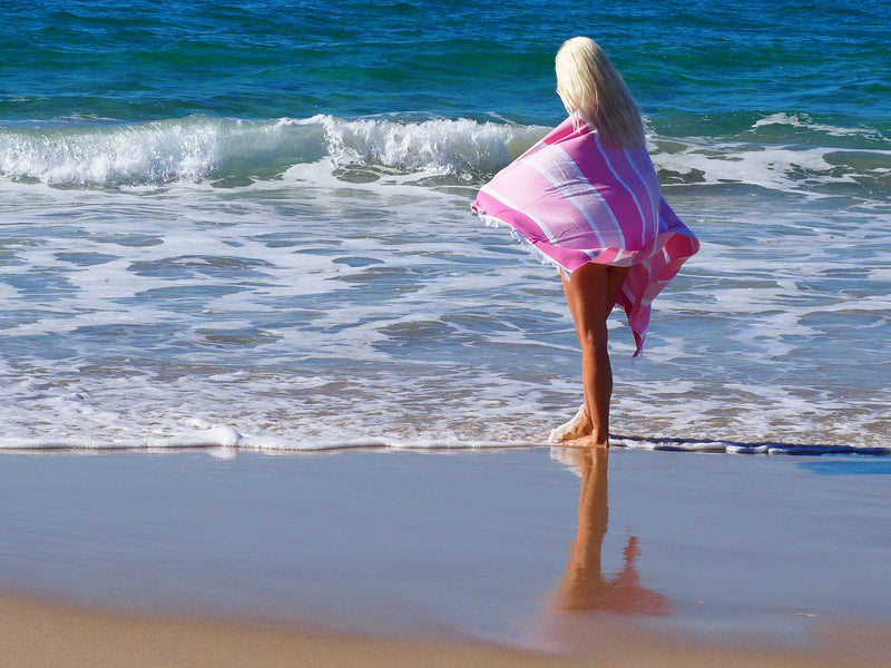 woman on beach with SORRENTO TURKISH COTTON TOWEL - CANDY