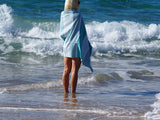 woman with SORRENTO TURKISH COTTON TOWEL - OCEAN